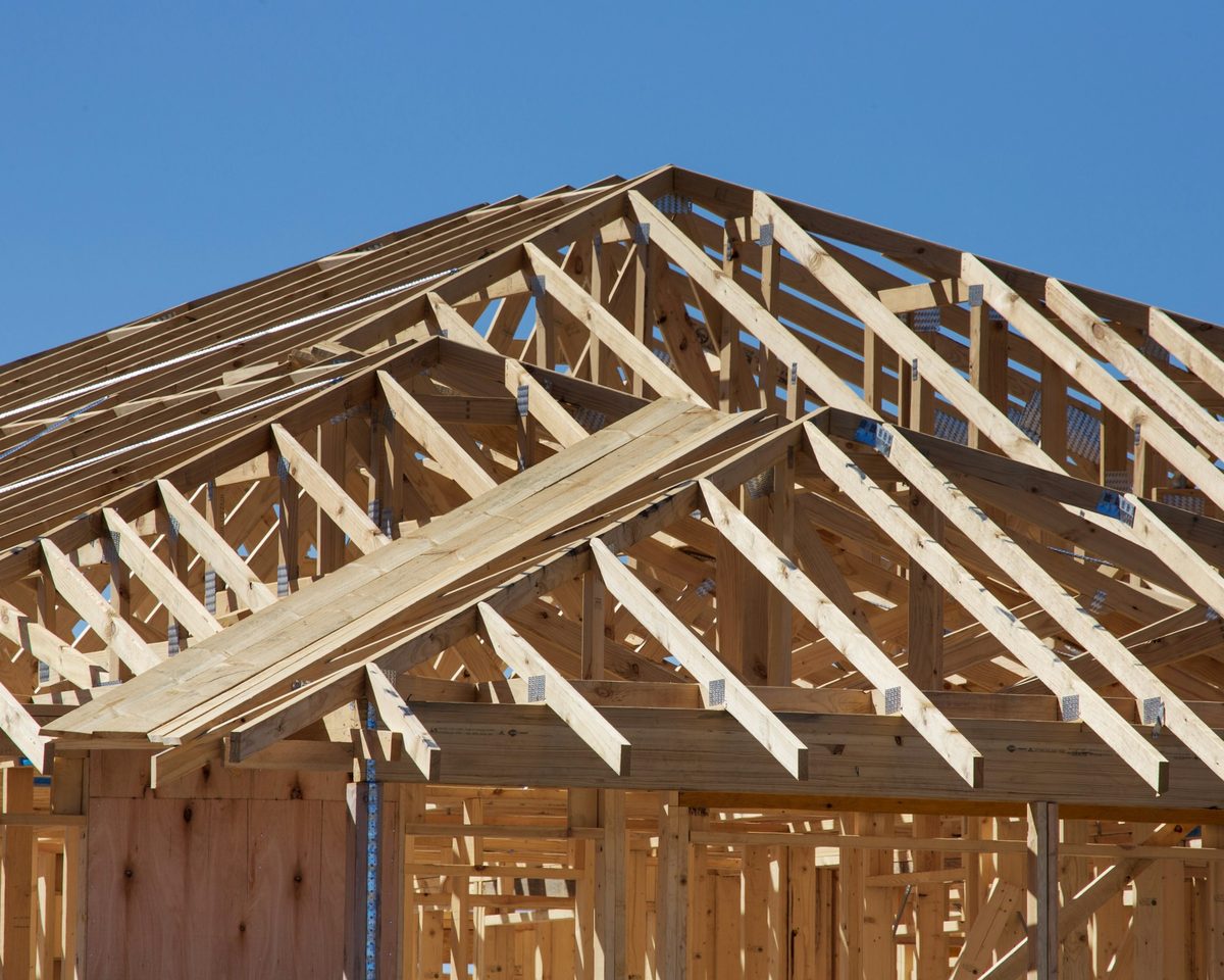 New roof trusses over the house against a clear sky