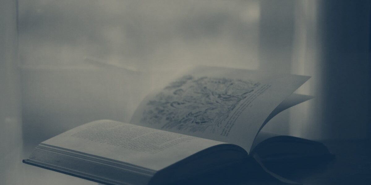 An open book on a table in low light