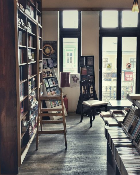 An empty bookshop with tall wooden shelves