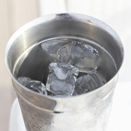 A steel tumbler packed with ice