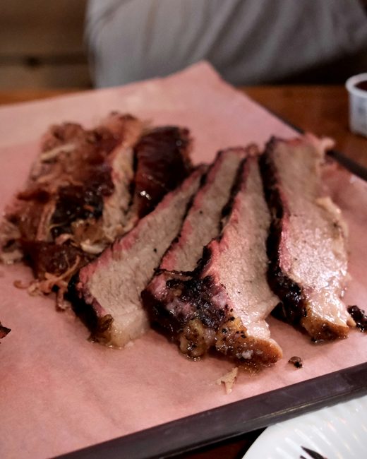 Sliced brisket on pink butcher paper