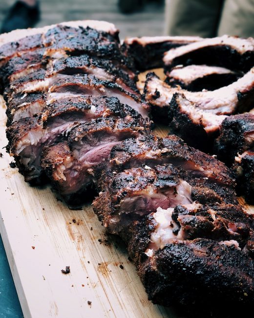 Racks of smoked ribs on a wooden board
