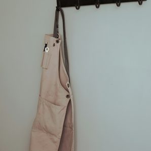A linen apron on a hook