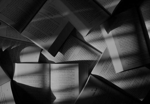 Open books fanned out under warm light