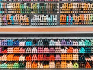 A wall of colored marker pens sorted by shade