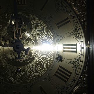 An ornate brass clock face with roman numerals
