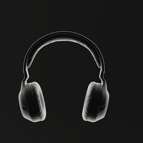 A pair of headphones rim lit against a black background