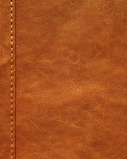 Close-up of tan full-grain leather with a stitched seam