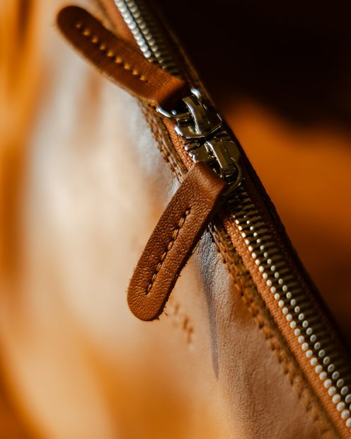A leather zip pocket inside the bag