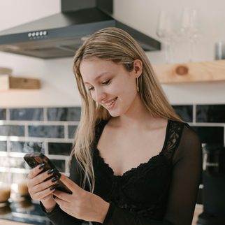 Woman checking her phone in a kitchen
