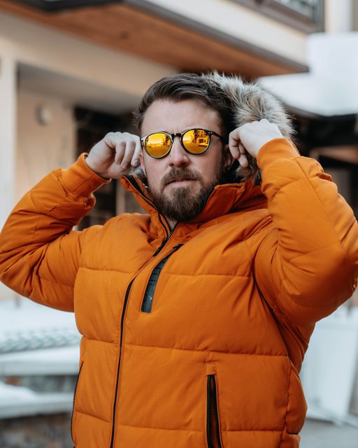 Man in an orange insulated puffer jacket