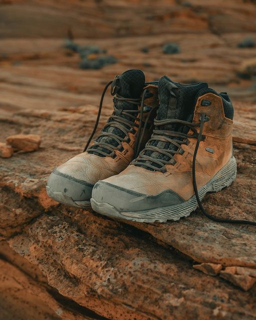 A pair of hiking boots on red sandstone