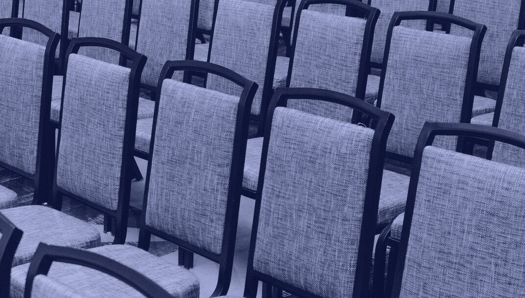Rows of empty chairs facing a stage in Union Hall