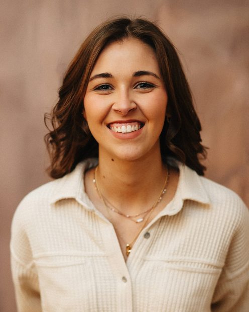 Céline Dubois smiling against a warm backdrop