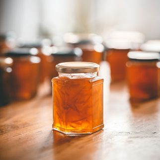 Jars of honey and preserves on a wooden table