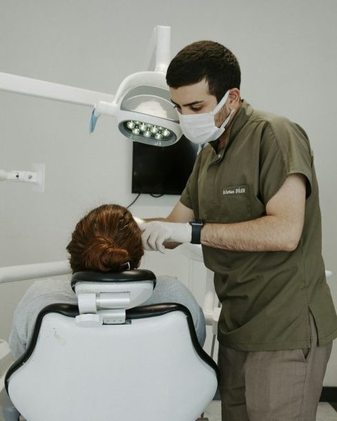 A dentist examining a patient in a bright treatment room