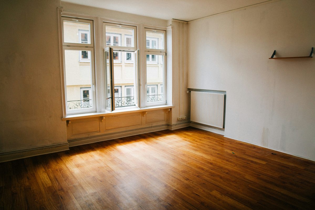 Sun across the wooden floor of an empty apartment, ready to move into