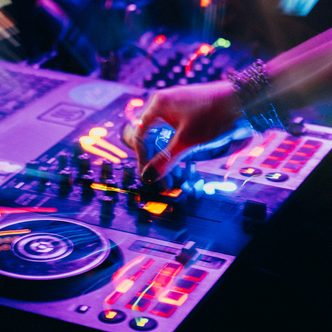 Hands on the mixer in the DJ booth