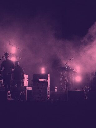 A band on a smoky stage lit by warm lamps