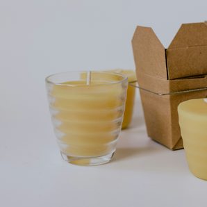 Beeswax candles in glass