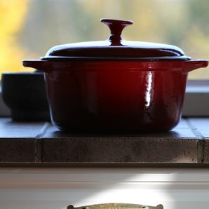A deep red cast iron pot