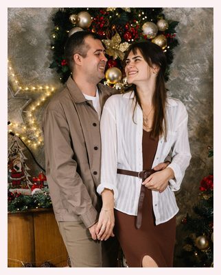 A couple laughing on the holiday set