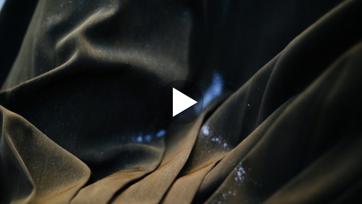 Play the Aperture teaser: a shape under dark fabric