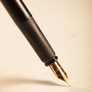 A fountain pen resting on a sheet of paper