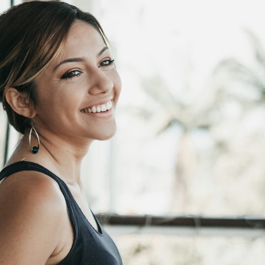 Dana, smiling by a window