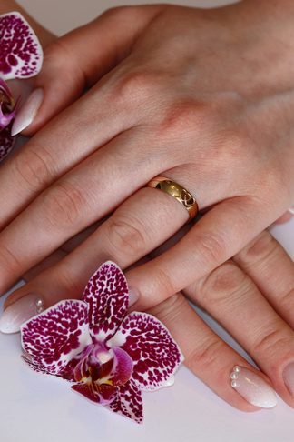 Soft pink ombre nails beside two magenta orchids