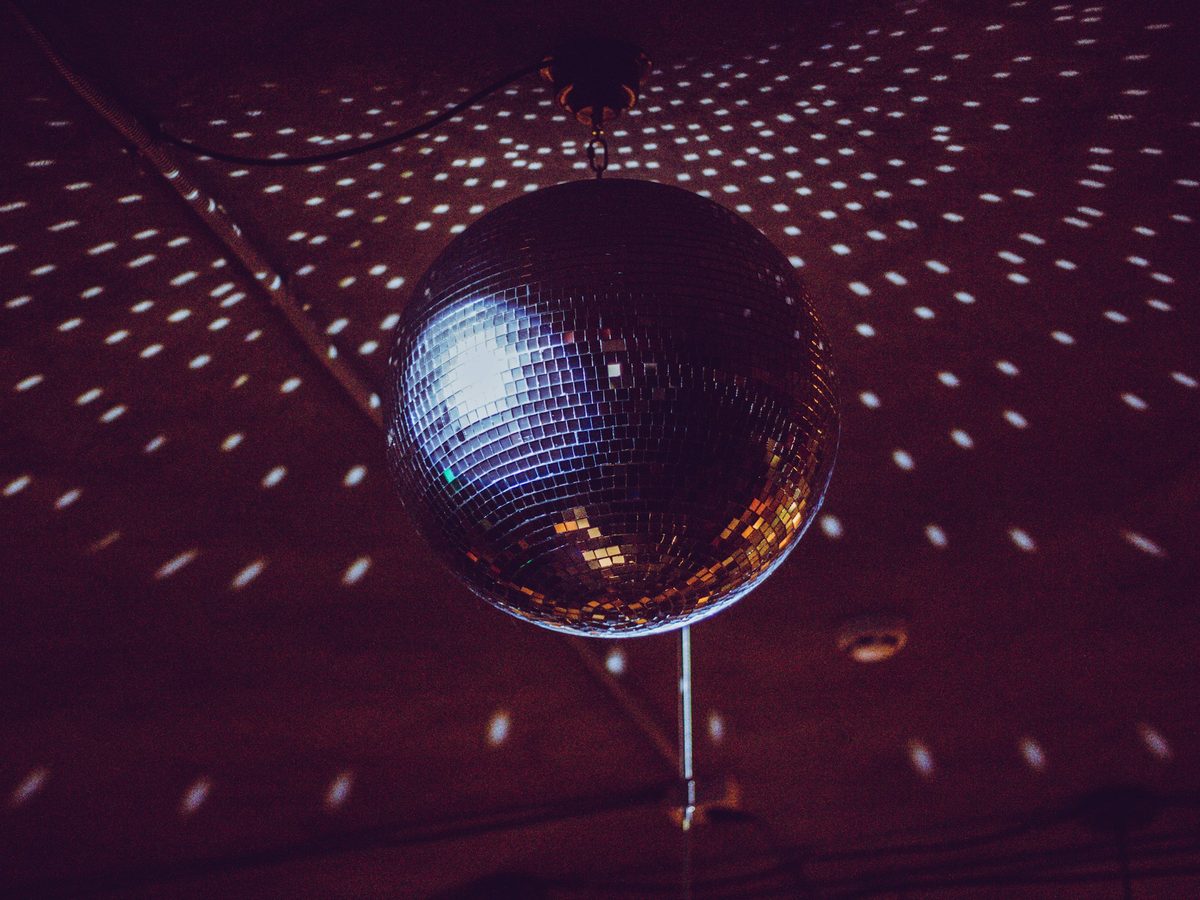 A mirror ball throwing points of light across a dark room