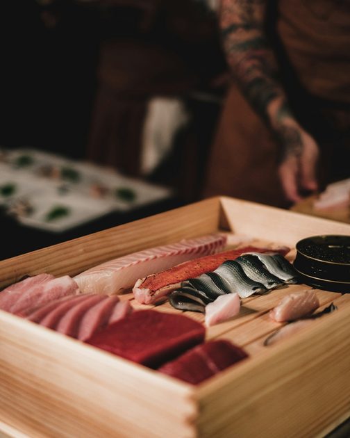 Cuts of fish laid out in a wooden box