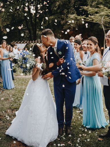 A couple kiss as confetti falls