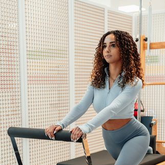 A client moving through a standing series on the reformer