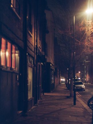 A quiet street at night under streetlights
