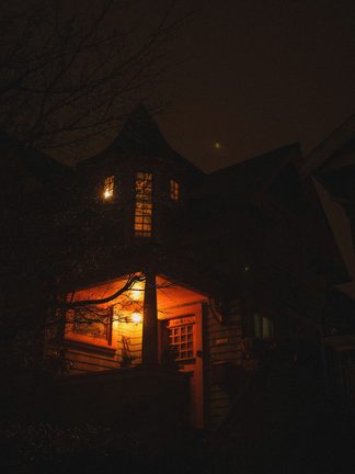 A house with one lit window at night