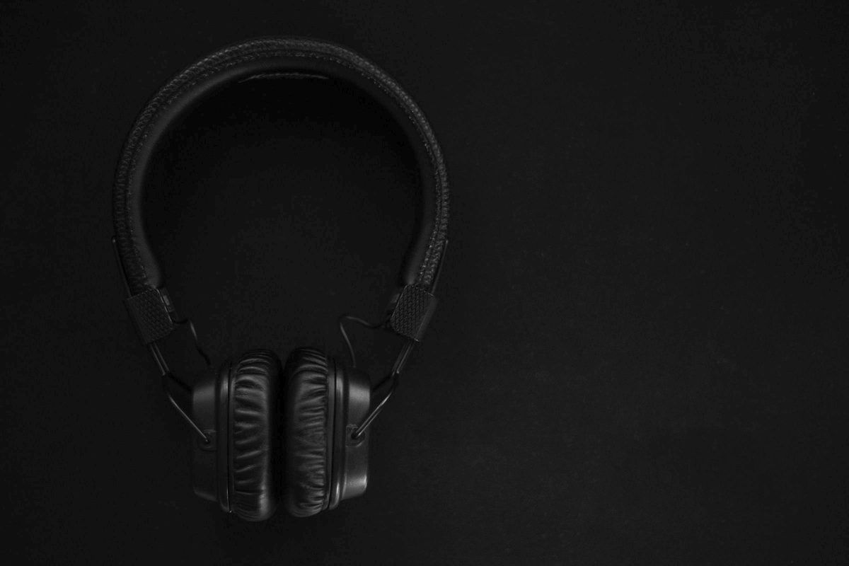 Matte black headphones standing in a dark room