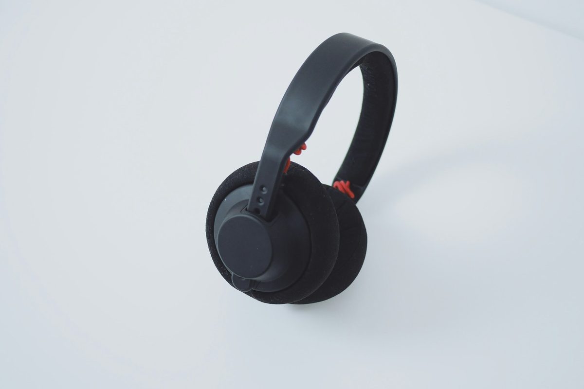 Matte black over-ear headphones resting on a white table