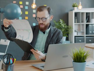 A property manager reviewing paperwork at a desk