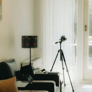 A camera on a tripod in a bright living room