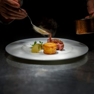 A chef plating a course