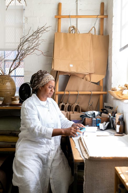Nora, the founder of Ashgrove House, wrapping an order at her studio table