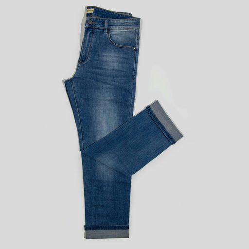 A pair of mid-wash jeans folded on a pale gray background