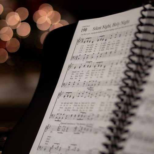 A spiral songbook open on a music stand