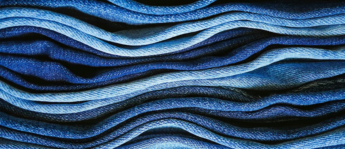 Stacked indigo denim folded into waves