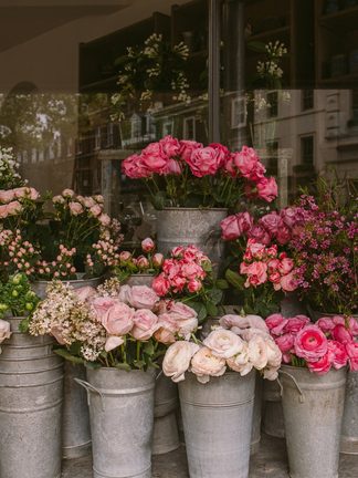 Zinc buckets of roses and peonies outside a florist
