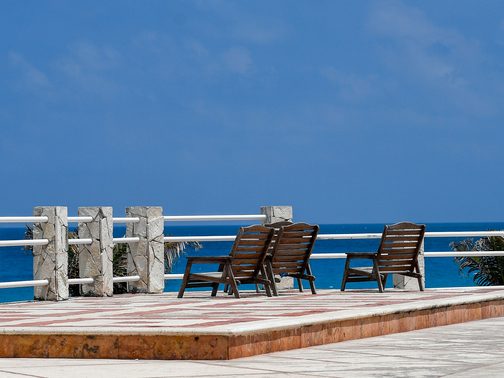 Deck chairs on a terrace above the sea