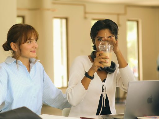 Two students working together at a laptop