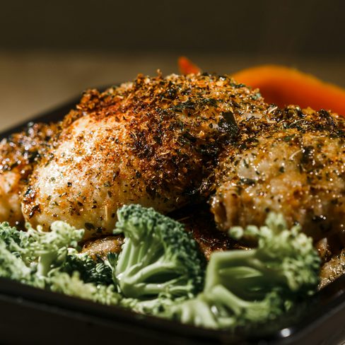 A tray of roasted chicken and vegetables