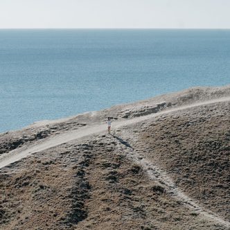 A footpath winding along a grassy headland above the sea
